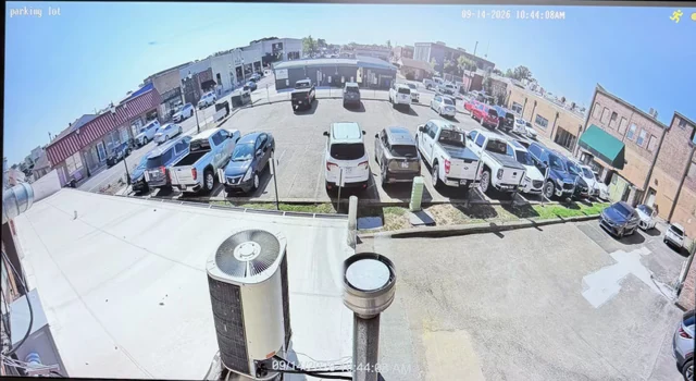 Wide panoramic surveillance camera view of a commercial parking lot